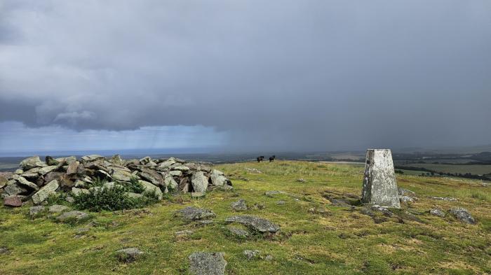 Turning cooler with showers and uncertainty around a weekend low pressure
