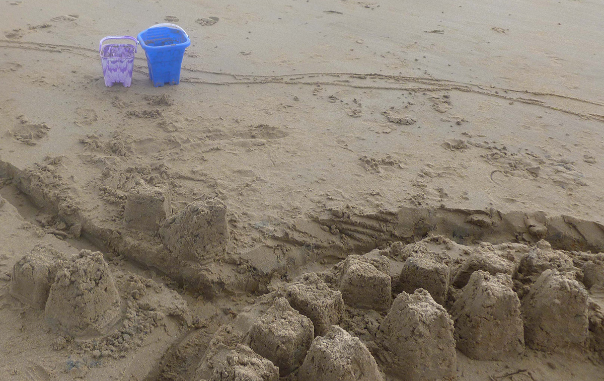 Bank holiday beach and sandcastle