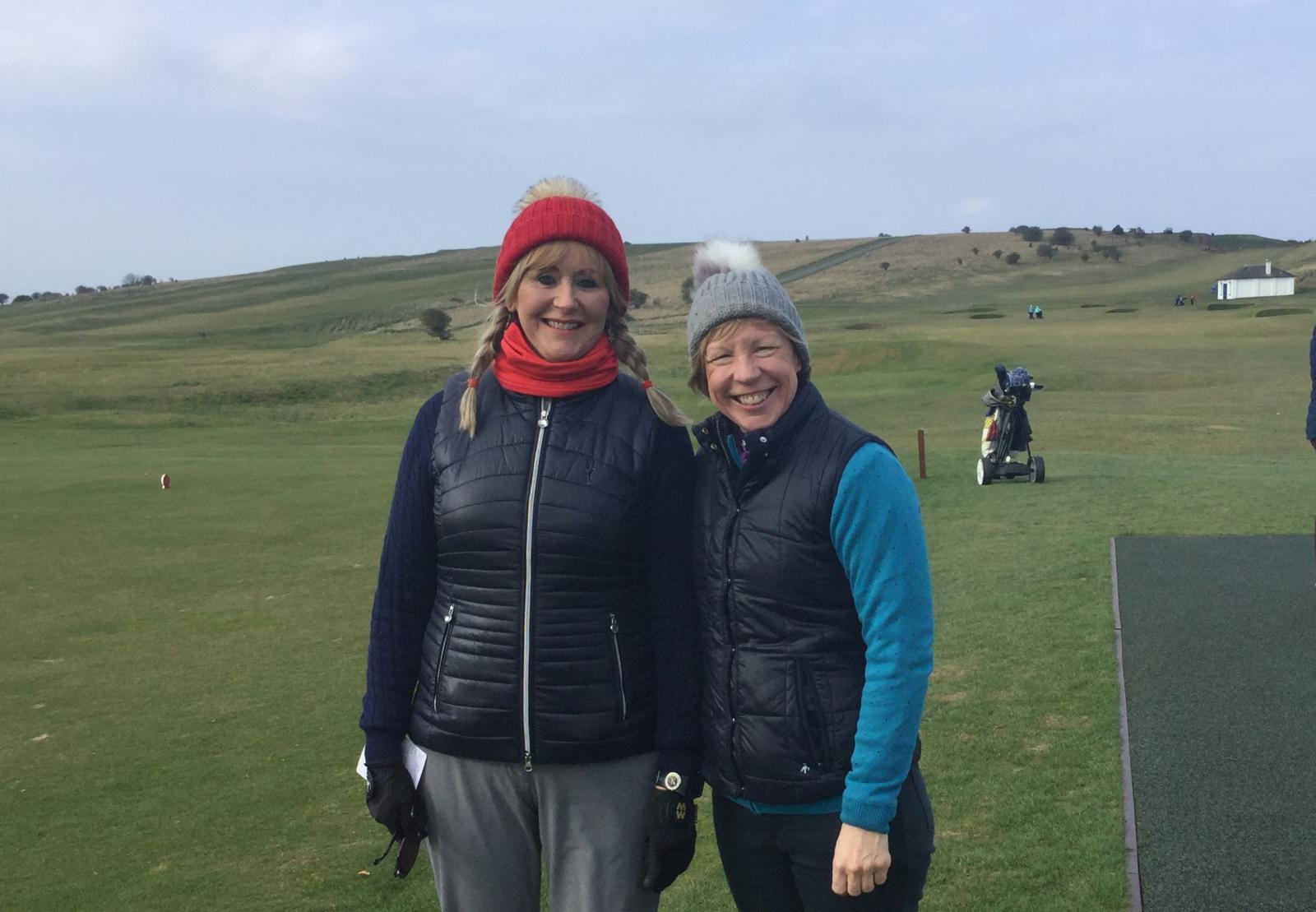 Dressed for the weather, two Gullane golfers in hats and coats